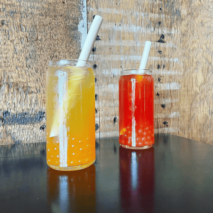 Citrus and bettery boba drinks side by side