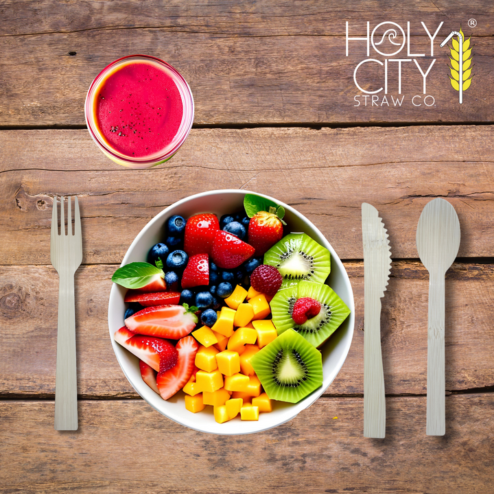Holy City Straw Co. unwrapped bamboo cutlery next to color fruit place setting
