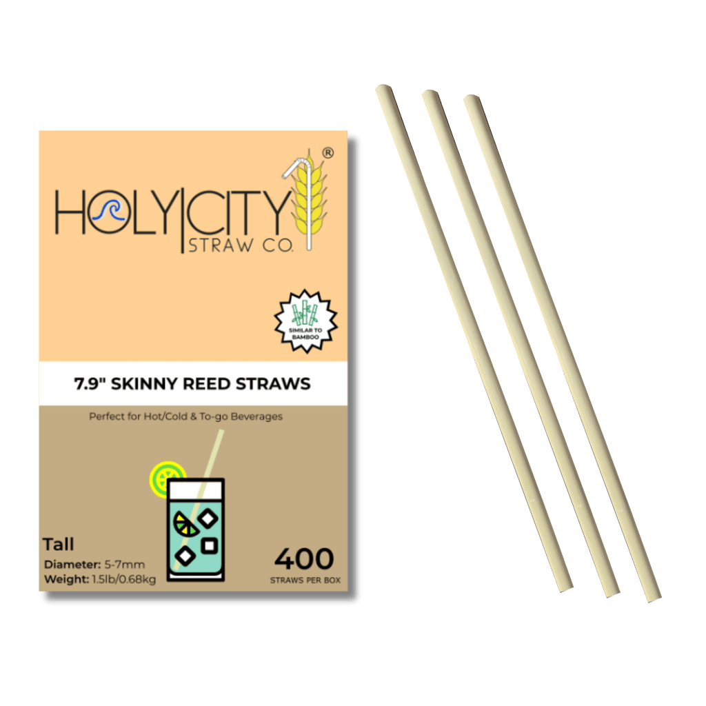 A box labeled "Holy City Straw Co." is displayed with "7.9'' Skinny Reed Straws" written on it. The box is peach-colored and contains a badge that reads "Similar to Bamboo." Next to the box, three biodegradable reed straws are arranged parallel to each other. The packaging mentions that these straws are perfect for hot, cold, and to-go beverages, and the box contains 400 straws with a diameter of 5-7mm.