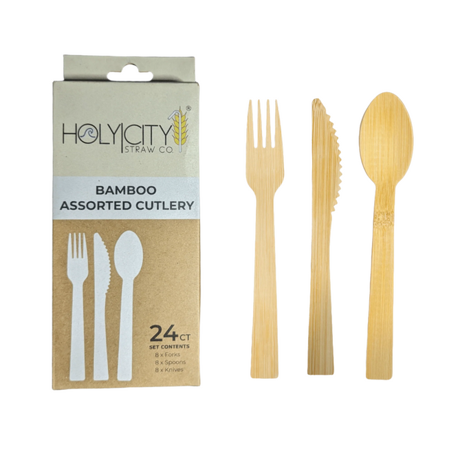 Packaging and product display for Holy City Straw Co.'s bamboo assorted cutlery set, which includes 24 pieces: eight forks, eight spoons, and eight knives, all crafted from sustainable bamboo for environmentally conscious consumers. The box is crafted from recyclable materials and stands next to a sample fork, knife, and spoon laid side by side, showcasing their elegant and natural bamboo design