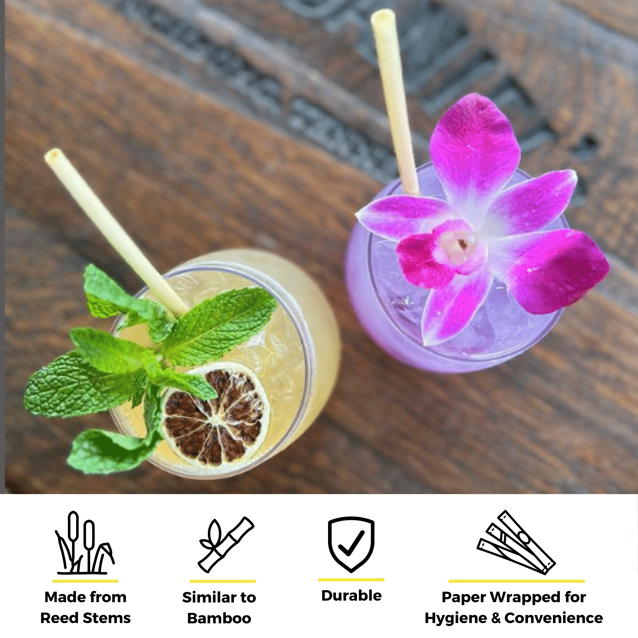 Two colorful cocktails sit on a wooden surface. One is garnished with mint leaves and a dried citrus slice, while the other has a purple orchid flower. Both glasses contain cocktail skinny reed straws made from reed stems. Icons at the bottom emphasize that these straws are made from reed stems, similar to bamboo, durable, and paper wrapped for hygiene and convenience..