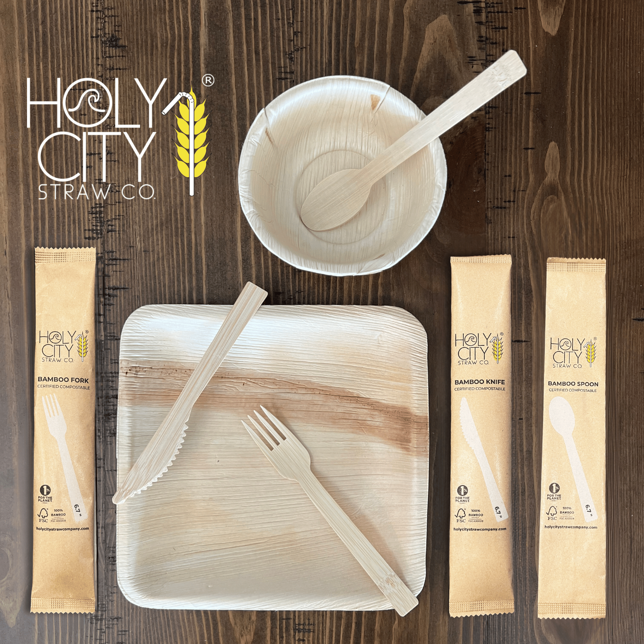 Wrapped bamboo cutlery set by Holy City Straw Co. featuring eco-friendly spoon fork and knife on wooden background