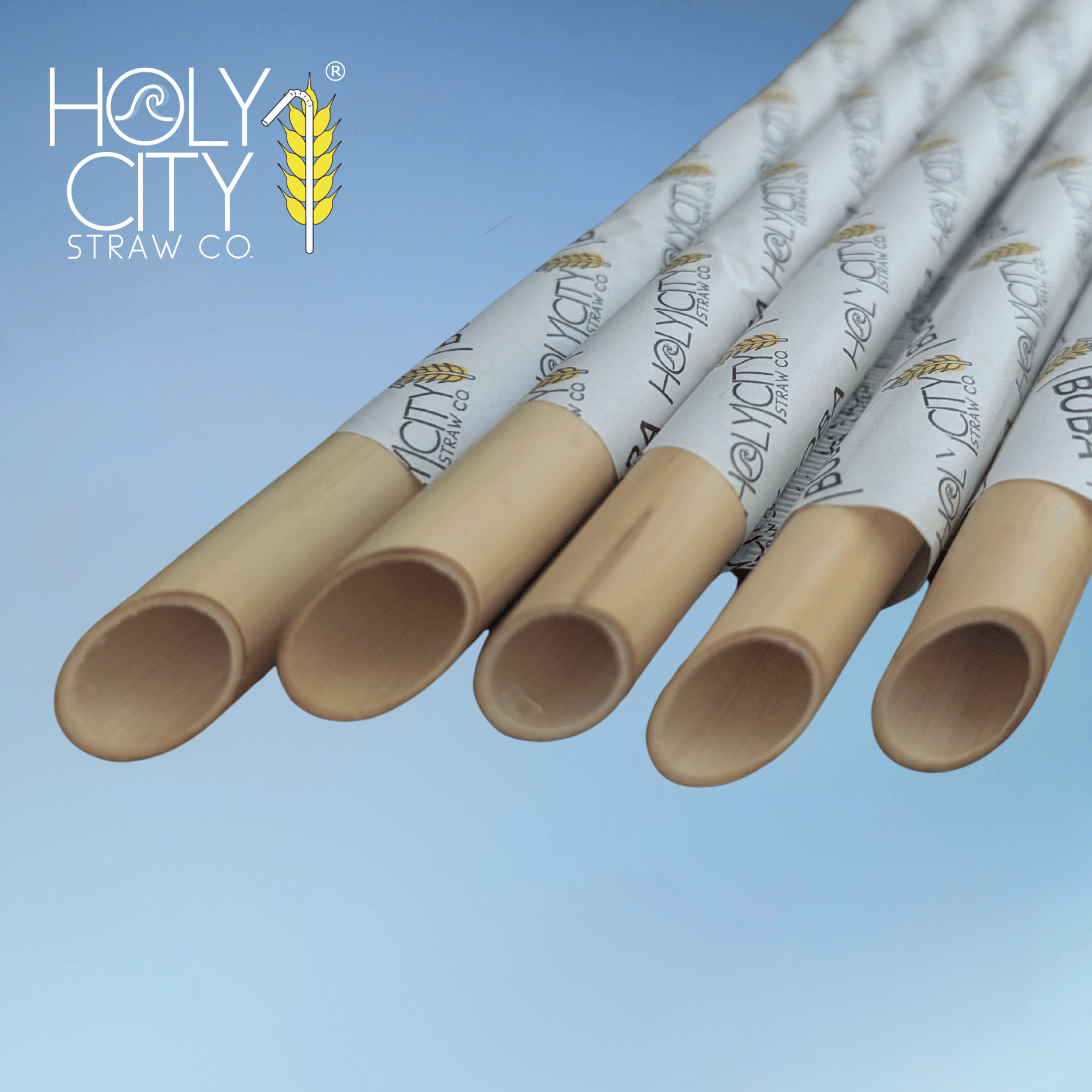Angled boba reed stem straws wrapped in branded paper by Holy City Straw Co., designed for tapioca pearls and thick beverages with a wide, natural opening.