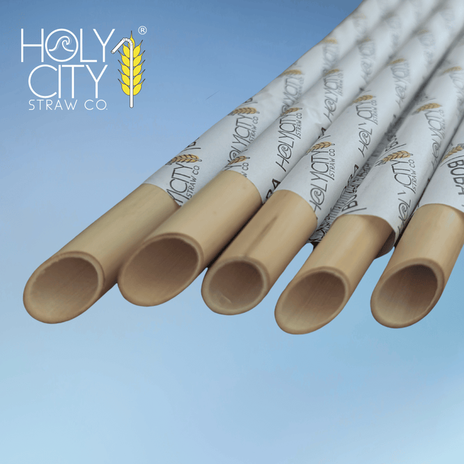Angled boba reed stem straws wrapped in branded paper by Holy City Straw Co., designed for tapioca pearls and thick beverages with a wide, natural opening.