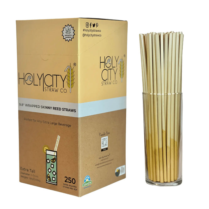 Right side view of Holy City Straw Co. box of 250 9.8-inch wrapped skinny reed straws, perfect for extra-large beverages, shown with a glass containing the straws.