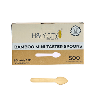 Holy City Straw Co.'s 500-pack box of bamboo mini taster spoons. The box is made from eco-friendly cardboard with the company's logo and details like '100% bamboo,' '96mm/3.8 inch,' and '500 disposable spoons.' A single bamboo mini taster spoon is displayed below the box to show the spoon's shape and size