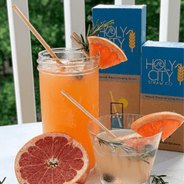 Tall and Short Cocktail alongside a tall and cocktail 100 count boxes of Holy City Straw Company wheat straws