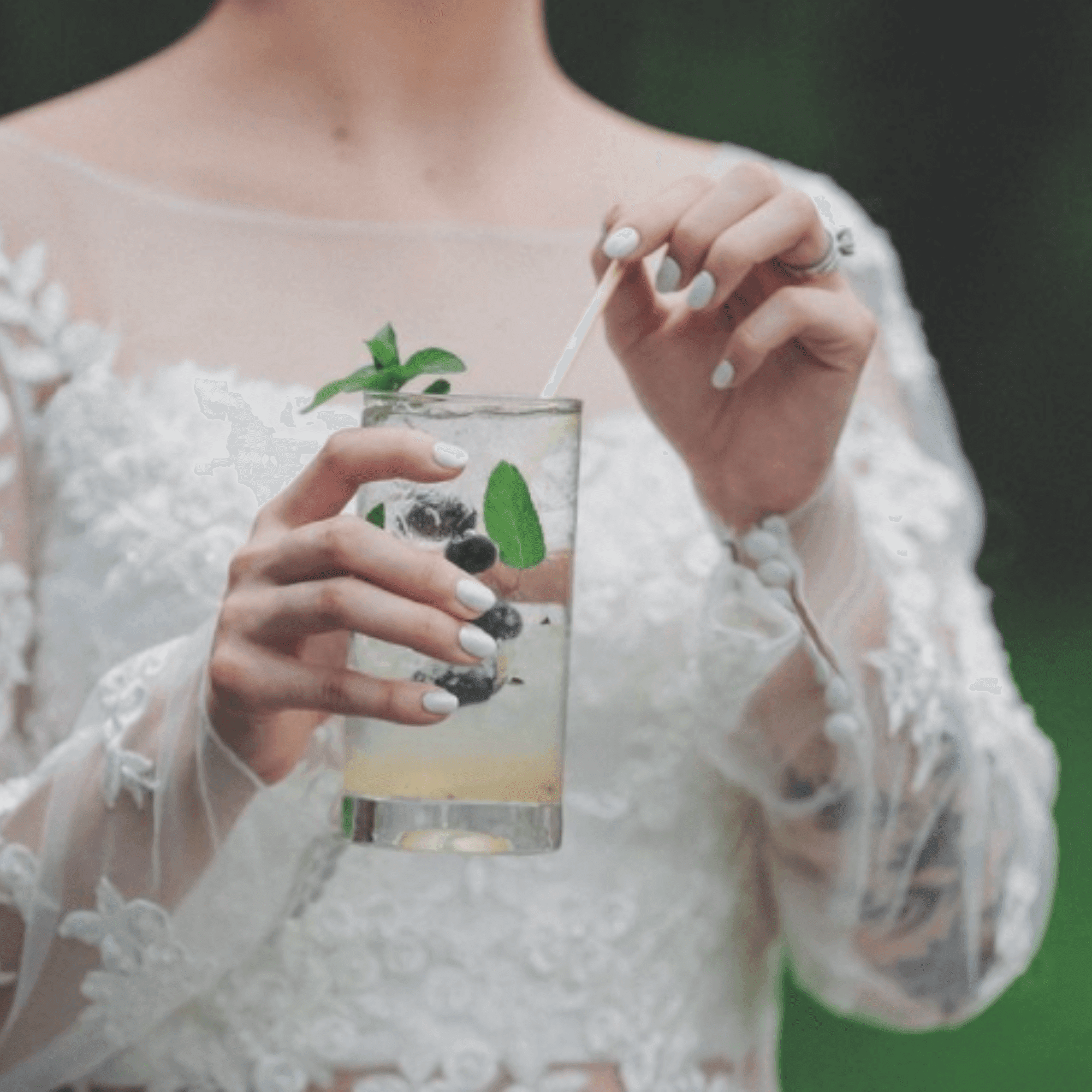 Bride holding wheat straw in drink