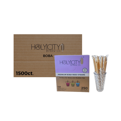 Holy City Straw Co wrapped boba reed straws case of 1500ct next to glass of straws transparent