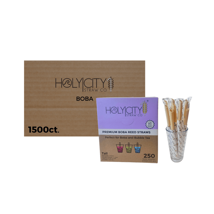 Holy City Straw Co wrapped boba reed straws case of 1500ct next to glass of straws transparent