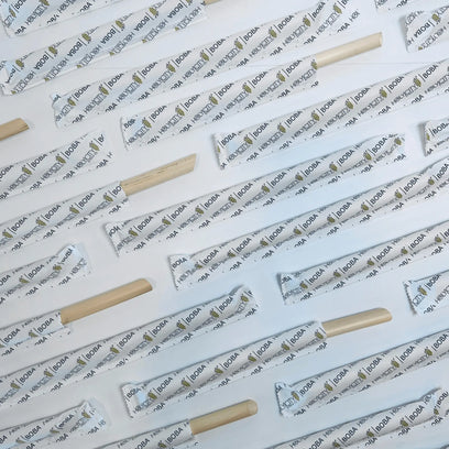 Holy city straw co wrapped and unwrapped boba reed straws angled and lined up next to each other