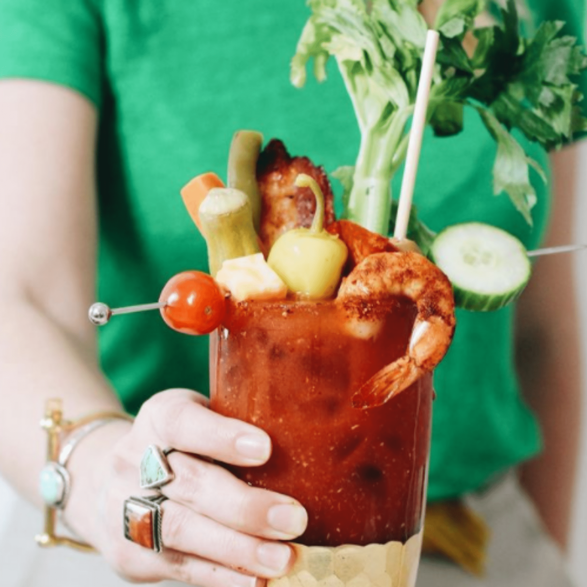 bloody mary with many garnishes and a tall wheat straw